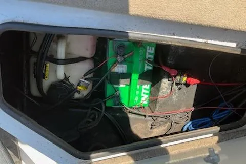 Slide: The Image of Battery compartment of 2004 Ranger 210 Reata boat with wiring and fluid containers. - 8