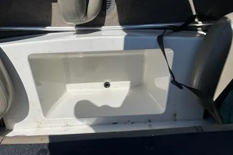 Slide: The Image of 2004 Ranger 210 Reata boat interior with storage compartment and seating. - 9