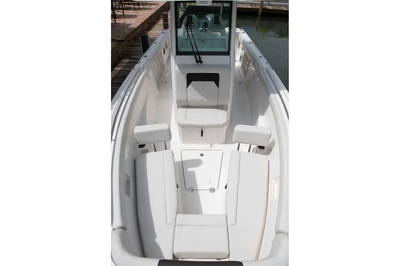 Slide: The Image of 2027 Sailfish 272 CC boat interior with white seating and sleek design. - 10