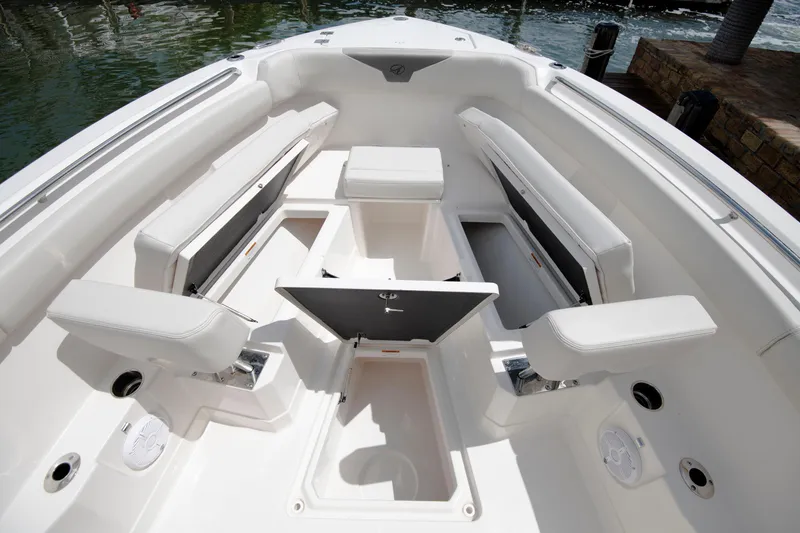 Slide: The Image of 2027 Sailfish 272 CC boat interior with white seating and storage compartments. - 12