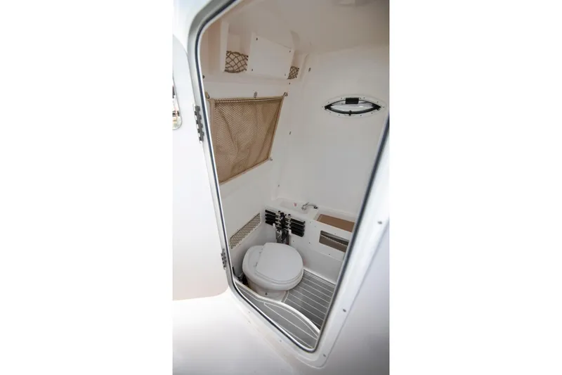 Slide: The Image of Interior view of 2027 Sailfish 272 CC boat bathroom with toilet and storage. - 13