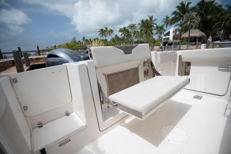 Slide: The Image of 2027 Sailfish 272 CC boat interior with foldable seat, dockside view. - 19