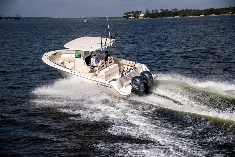 Slide: The Image of 2027 Sailfish 272 CC boat cruising on open water with dual engines. - 3