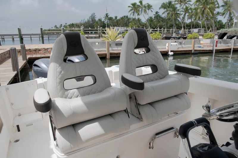 Slide: The Image of Luxury seating on 2027 Sailfish 272 CC boat, docked by tropical waterfront. - 9