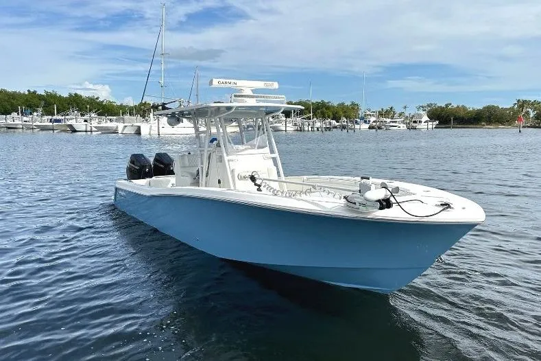 Slide: The Image of 2021 Invincible 33 Open Fisherman boat on calm water near marina. - 3