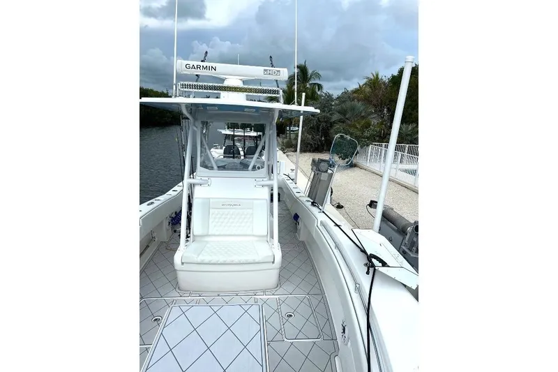 Slide: The Image of 2021 Invincible 33 Open Fisherman boat with Garmin electronics, docked by a scenic waterfront. - 6