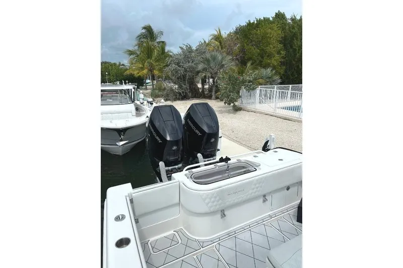 Slide: The Image of 2021 Invincible 33 Open Fisherman boat docked with twin Mercury engines. - 7