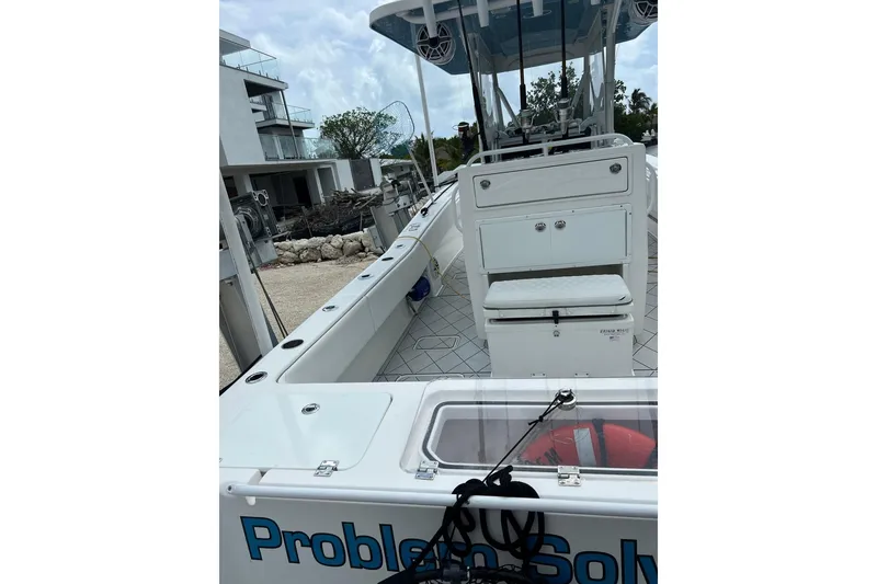 Slide: The Image of 2021 Invincible 33 Open Fisherman boat docked near modern buildings. - 8