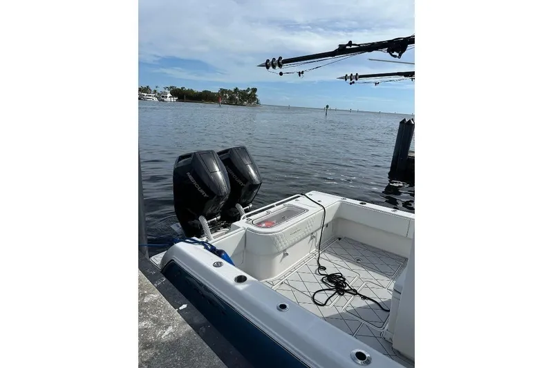 Slide: The Image of 2021 Invincible 33 Open Fisherman boat docked with twin Mercury engines. - 9