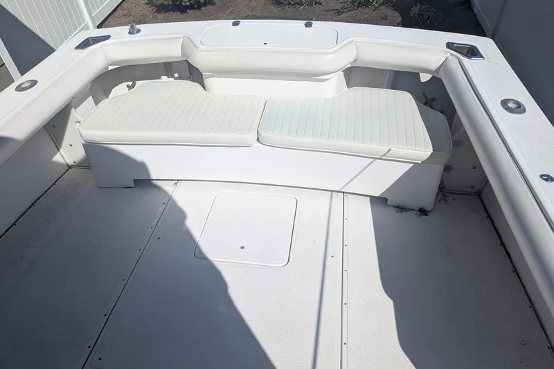 Slide: The Image of 1993 Shamrock 220 Walkaround boat interior with white cushioned seating. - 10