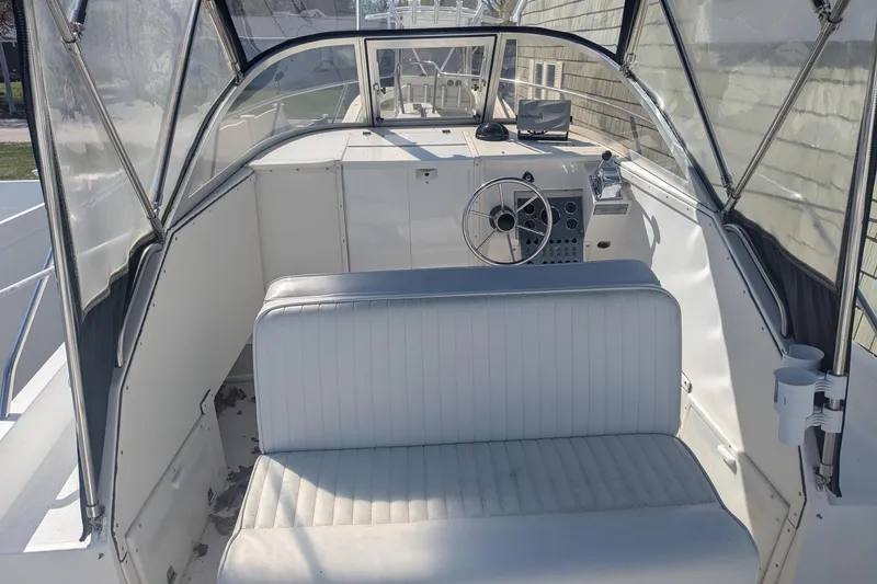 Slide: The Image of 1993 Shamrock 220 Walkaround boat interior with steering wheel and seating. - 11