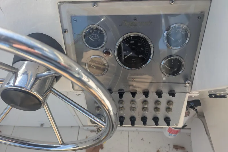Slide: The Image of 1993 Shamrock 220 Walkaround dashboard with steering wheel and gauges. - 15
