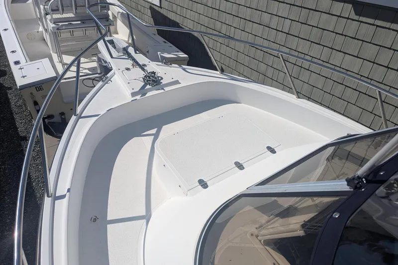 Slide: The Image of 1993 Shamrock 220 Walkaround boat deck with railing and seating area. - 21