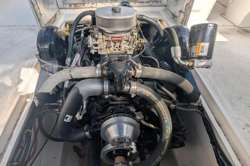Slide: The Image of Engine of a 1993 Shamrock 220 Walkaround boat, featuring detailed components and hoses. - 23