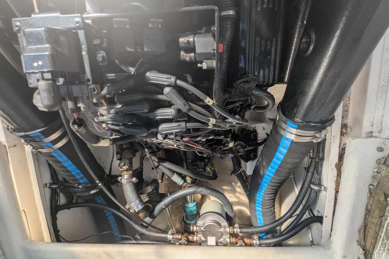 Slide: The Image of Engine compartment of a 1993 Shamrock 220 Walkaround boat, showing hoses and wiring. - 25