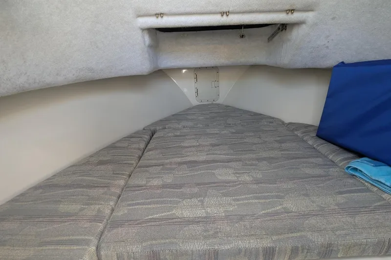 Slide: The Image of Interior cabin of a 1993 Shamrock 220 Walkaround boat with cushioned sleeping area. - 28