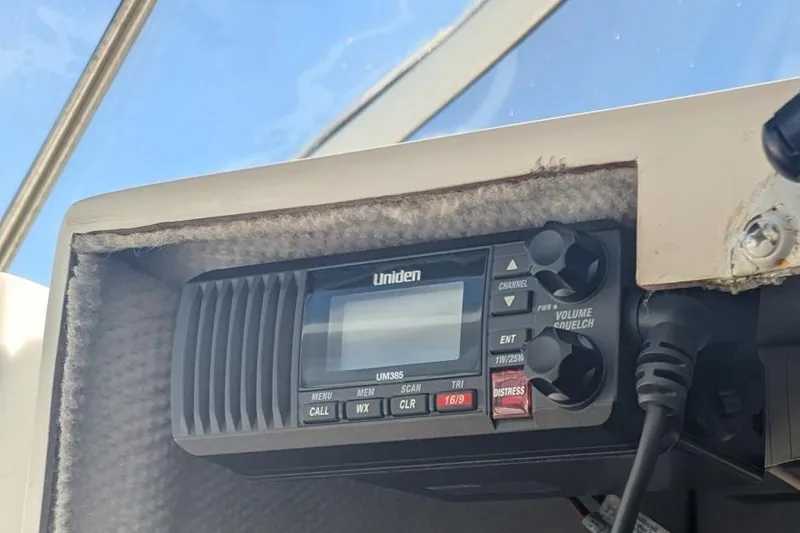 Slide: The Image of Uniden UM385 radio installed on a 1993 Shamrock 220 Walkaround boat dashboard. - 29