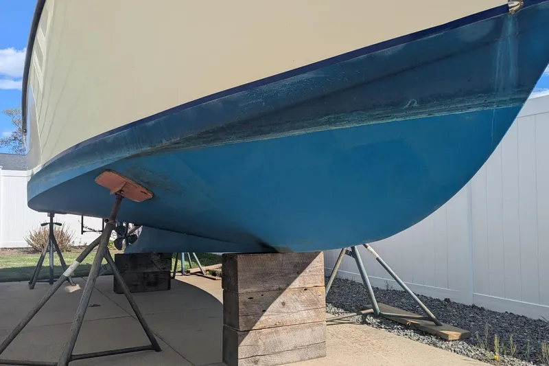 Slide: The Image of 1993 Shamrock 220 Walkaround boat on stands, blue hull, outdoor setting. - 6