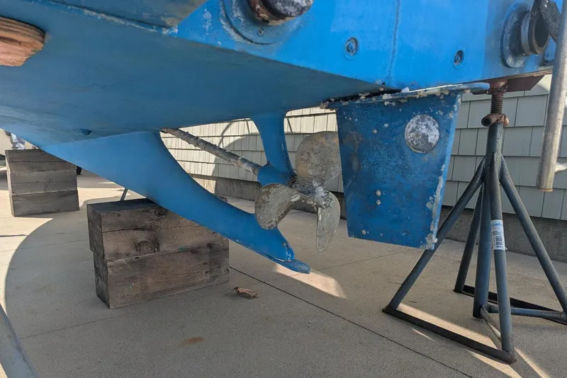 Slide: The Image of 1993 Shamrock 220 Walkaround boat propeller and rudder on dry dock. - 7