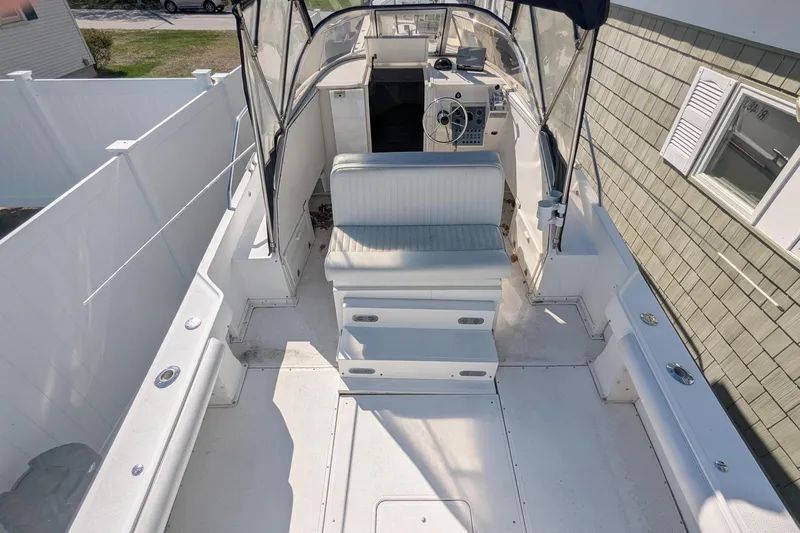 Slide: The Image of 1993 Shamrock 220 Walkaround boat interior with seating and steering console. - 8