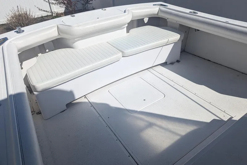 Slide: The Image of 1993 Shamrock 220 Walkaround boat interior with white seating and spacious deck. - 9