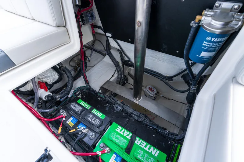 Slide: The Image of Battery compartment of 2027 Sailfish 232 CC boat with wiring and Yamaha fuel filter. - 17