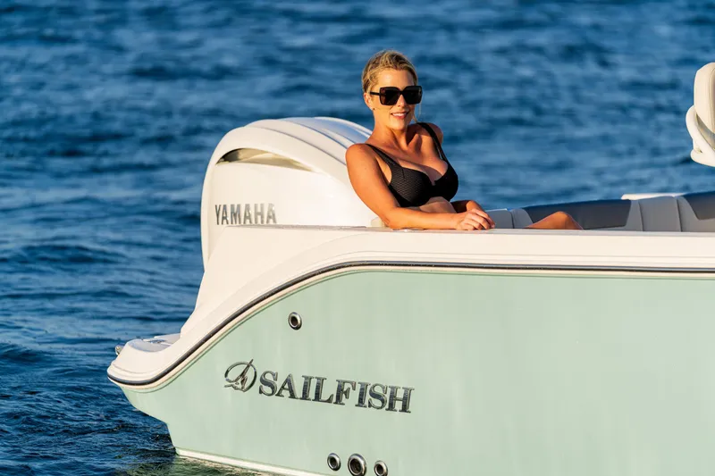 Slide: The Image of Woman relaxing on a 2027 Sailfish 232 CC boat with Yamaha engine on the water. - 25