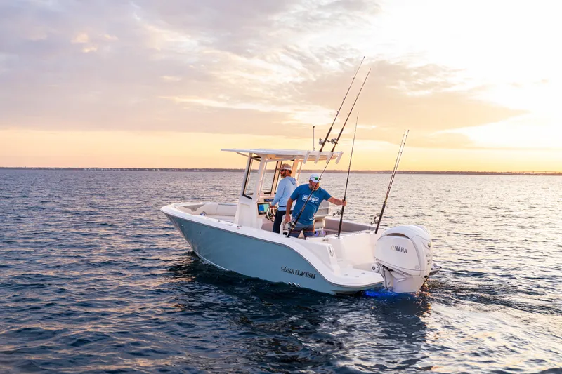 Slide: The Image of 2027 Sailfish 232 CC boat on water at sunset with fishing rods. - 3