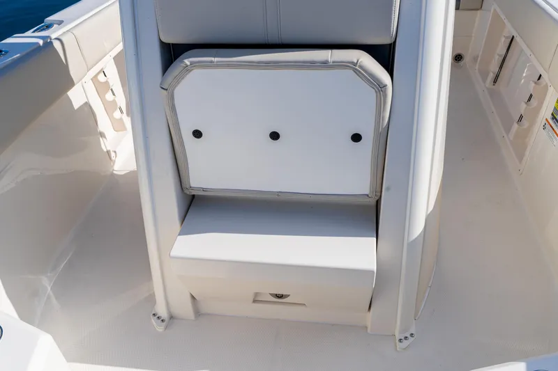 Slide: The Image of 2027 Sailfish 232 CC boat interior with cushioned seating and storage compartment. - 8