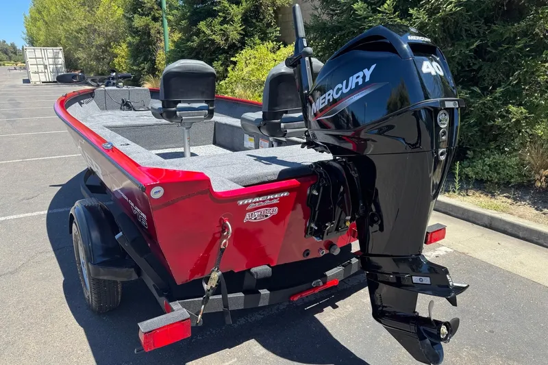 Slide: The Image of Red 2026 Tracker Super Guide V-16 T boat with Mercury 40 outboard motor in parking lot. - 7