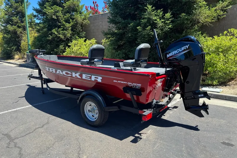 Slide: The Image of 2026 Tracker Super Guide V-16 T boat with Mercury engine in a parking lot. - 5