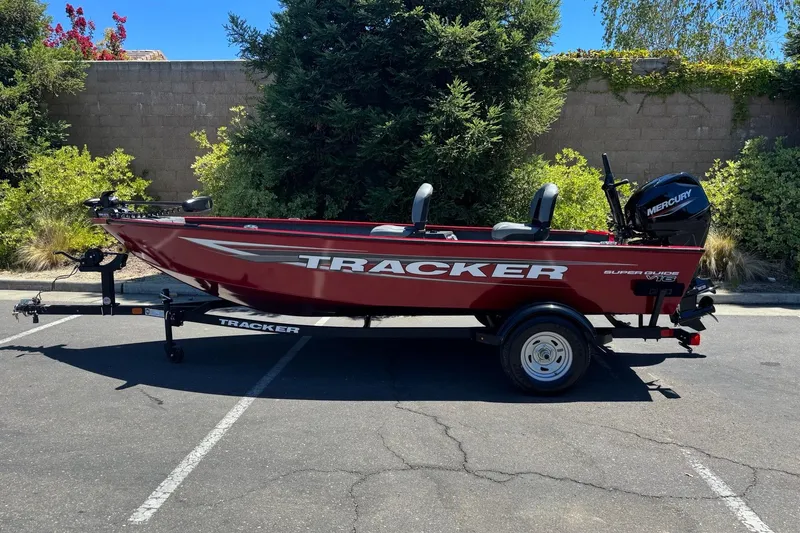 The Image of 2026 Tracker Super Guide V-16 T boat on trailer, parked outdoors. - 0
