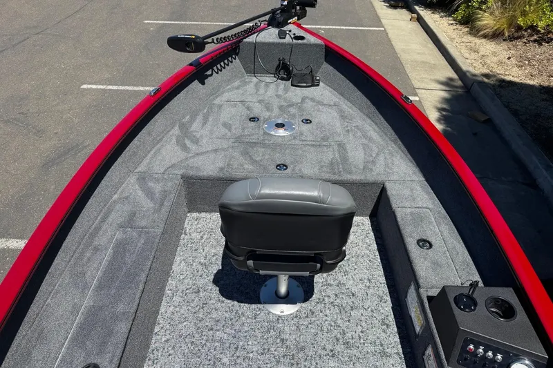 Slide: The Image of 2026 Tracker Super Guide V-16 T boat interior with gray seating and red trim. - 9