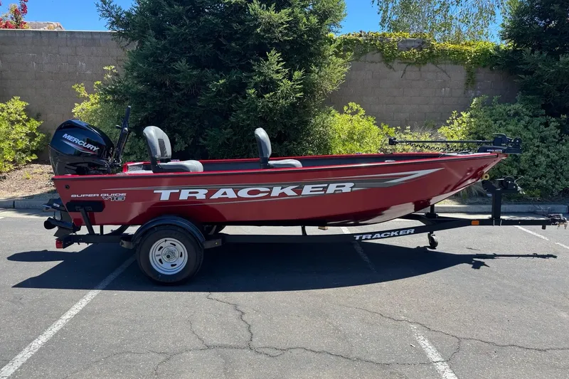 Slide: The Image of 2026 Tracker Super Guide V-16 T boat on trailer, parked outdoors. - 6