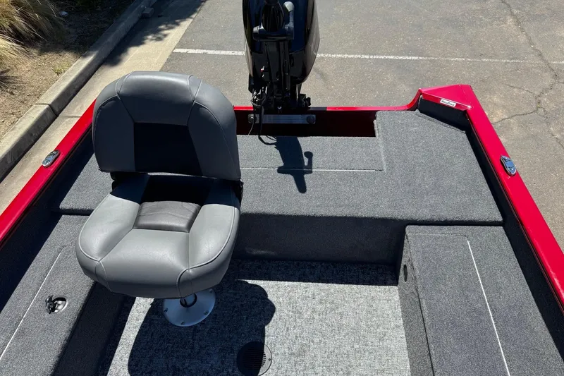 Slide: The Image of 2026 Tracker Super Guide V-16 T boat interior with gray seating and red trim. - 11