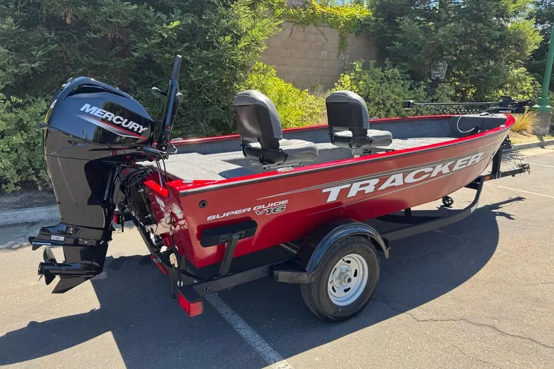 Slide: The Image of 2026 Tracker Super Guide V-16 T boat with Mercury engine, parked outdoors. - 4