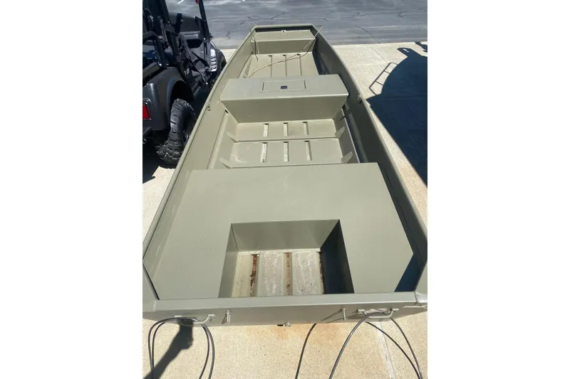 The Image of 2026 Tracker Grizzly 15 Jon boat, olive green, parked on concrete surface. - 0