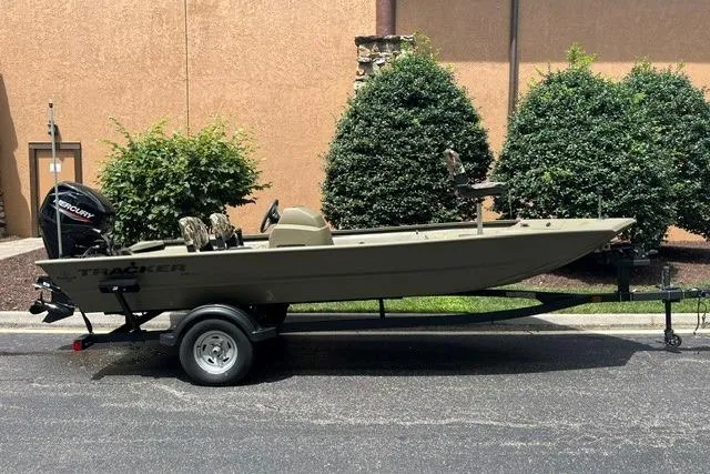 The Image of 2024 Tracker Grizzly 1648 SC boat on trailer, parked outdoors. - 0