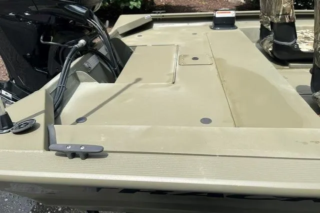 Slide: The Image of 2024 Tracker Grizzly 1648 SC boat deck with motor, showcasing durable design and functionality. - 8