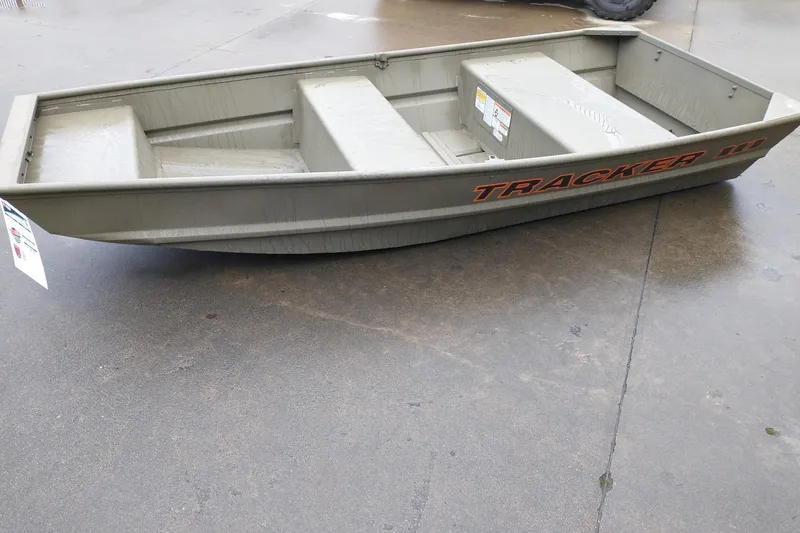 Slide: The Image of 2026 Tracker Grizzly 10 Jon boat on concrete surface, showcasing sturdy design. - 2