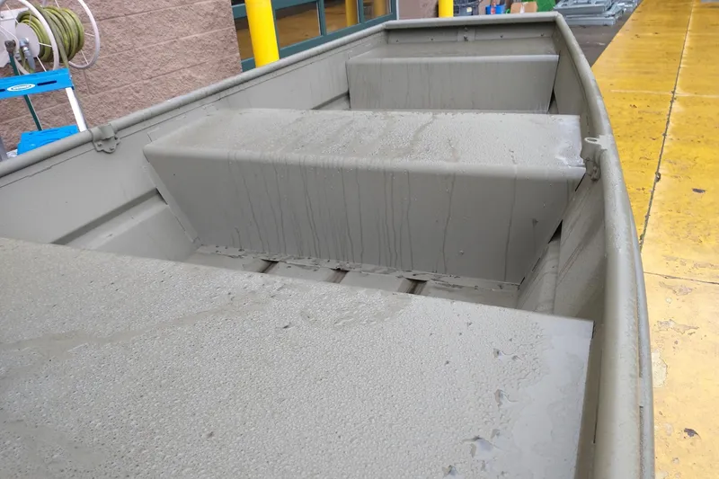 Slide: The Image of 2026 Tracker Grizzly 10 Jon boat interior with wet surfaces, showcasing sturdy construction. - 4