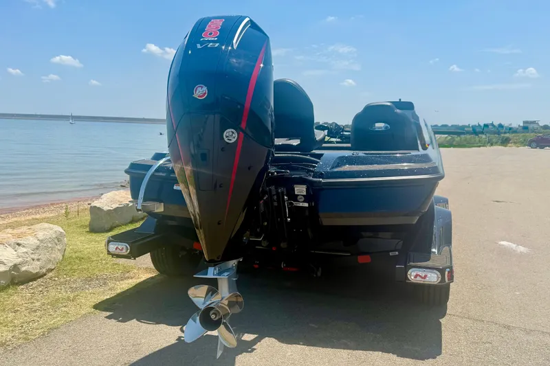 Slide: The Image of 2026 Nitro Z21 XL Pro boat with powerful engine, parked near a scenic lake. - 6