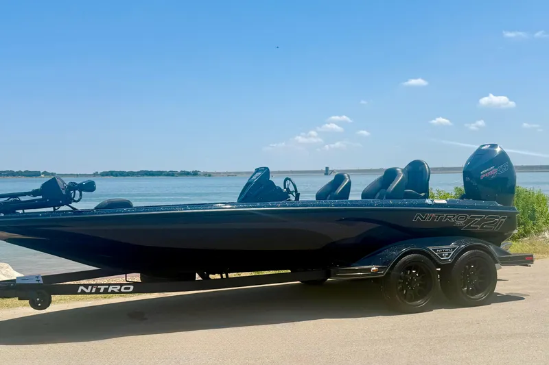 Slide: The Image of 2026 Nitro Z21 XL Pro boat on trailer by a scenic lake. - 7