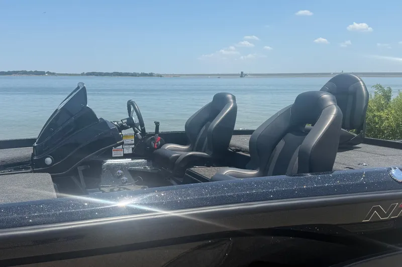 Slide: The Image of 2026 Nitro Z21 XL Pro boat interior with sleek seating by a serene lake. - 9
