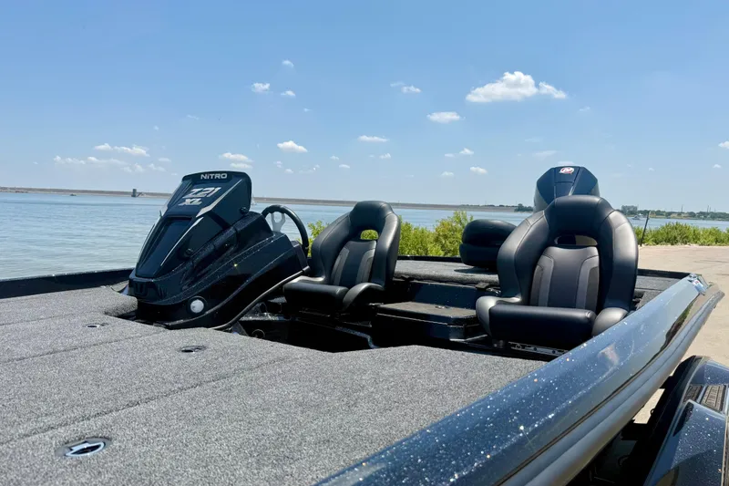 Slide: The Image of 2026 Nitro Z21 XL Pro boat with sleek design, parked by a serene lake. - 10