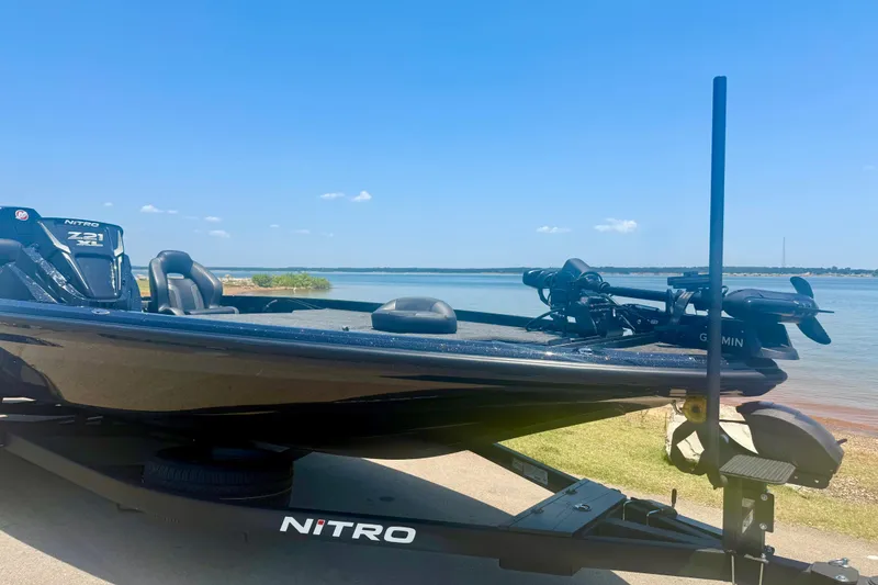 Slide: The Image of 2026 Nitro Z21 XL Pro boat by the lake on a sunny day. - 4
