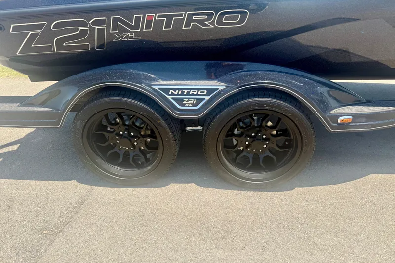 Slide: The Image of 2026 Nitro Z21 XL Pro trailer with black wheels on pavement. - 3