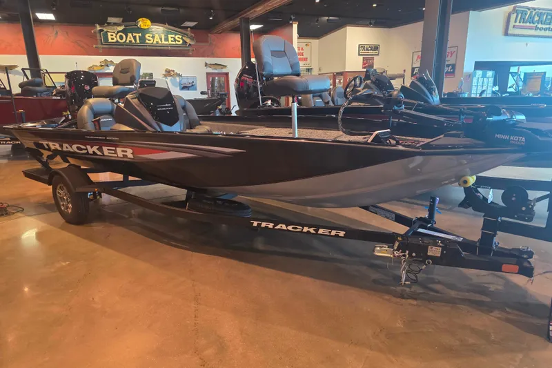The Image of 2026 Tracker Pro Team 190 boat displayed in showroom with trailer. - 0