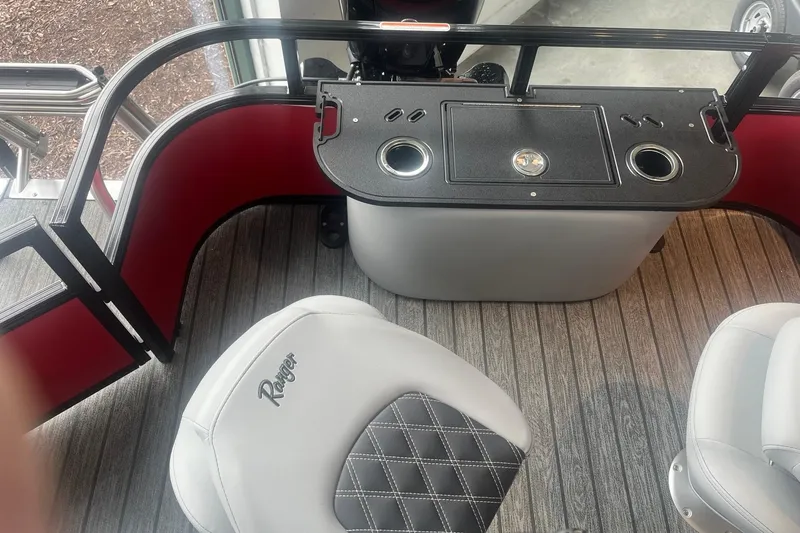 Slide: The Image of 2026 Ranger 220F boat interior with seating and console, featuring cup holders and stylish design. - 4