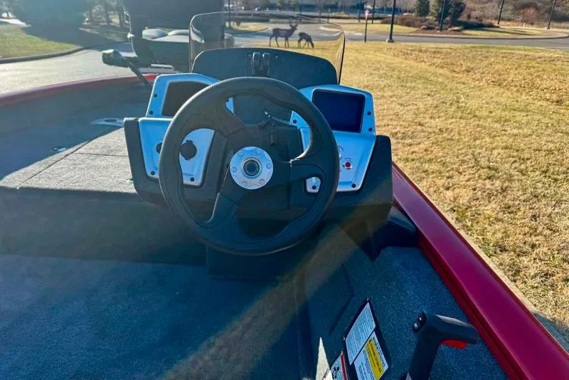 Slide: The Image of 2026 Tracker Pro Team 175 Crappie Edition boat dashboard with steering wheel and controls. - 6